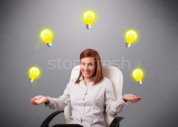 Młodych pani posiedzenia żonglerka żarówki piękna Zdjęcia stock © ra2studio