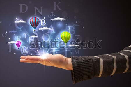 Worker with airbrush and colorful abstract clouds and balloons Stock photo © ra2studio
