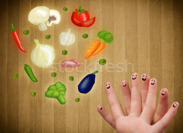 Stock photo: Happy smiley face fingers cheerfully looking at illustration of colorful healthy vegetables