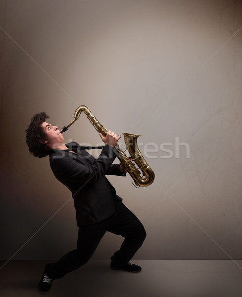 Young musician playing on saxophone Stock photo © ra2studio