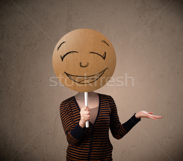 Young woman holding a smiley face board Stock photo © ra2studio