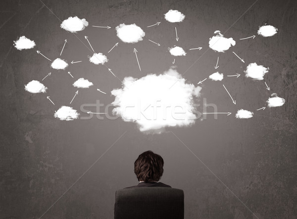 Businessman sitting with cloud technology above his head Stock photo © ra2studio