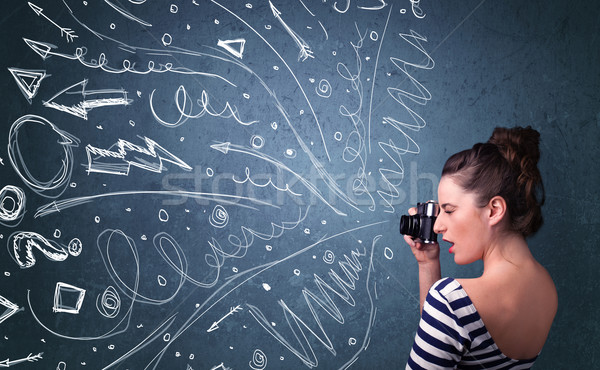 Photographer shooting images while energetic hand drawn lines an Stock photo © ra2studio