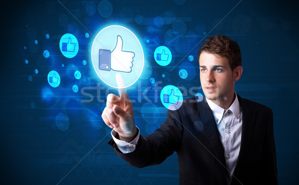 Stock photo: Handsome person pressing thumbs up button on modern social netwo