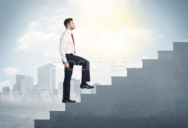 Businessman climbing up a concrete staircase concept Stock photo © ra2studio