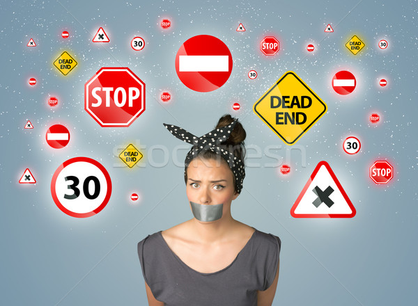 Young woman with glued mouth and traffic signals Stock photo © ra2studio