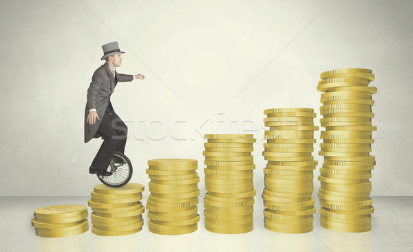 Business man riding monocycle up on coin graph Stock photo © ra2studio