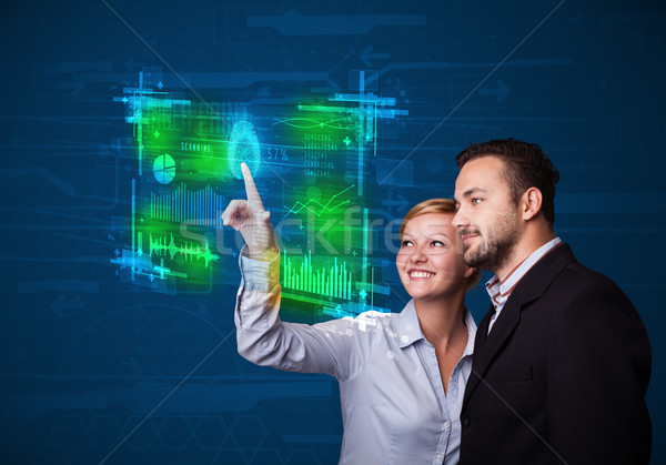 Young business couple pressing modern technology panel with fing Stock photo © ra2studio