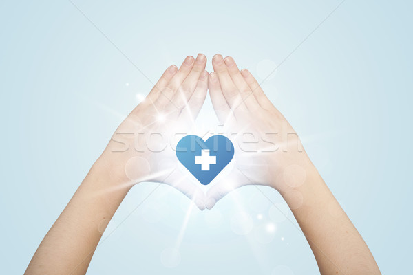 Hands creating a form with heart blue cross Stock photo © ra2studio
