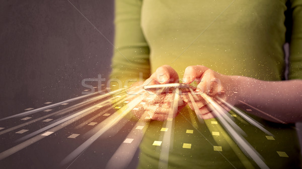 Person holding smarthphone with technology light applications Stock photo © ra2studio