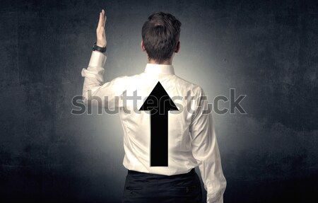 Businessman standing in front of a strong hero vision Stock photo © ra2studio