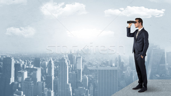 Man looking forward from the top of a skyscraper Stock photo © ra2studio