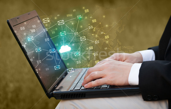 Hand using laptop with centralized cloud computing system concept Stock photo © ra2studio