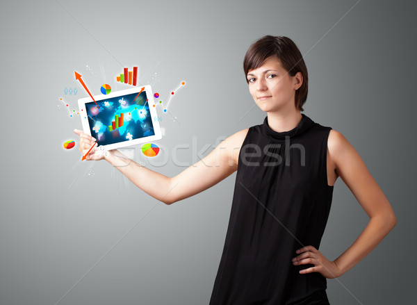 woman holding modern tablet with colorful diagrams and graphs Stock photo © ra2studio