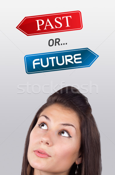 Young girl looking at positive negative signs Stock photo © ra2studio