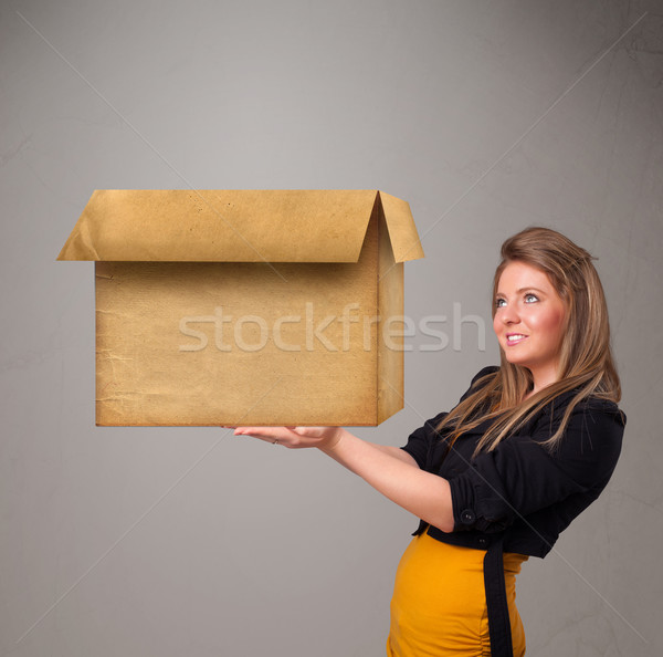 Young woman holding an empty cardboard box Stock photo © ra2studio