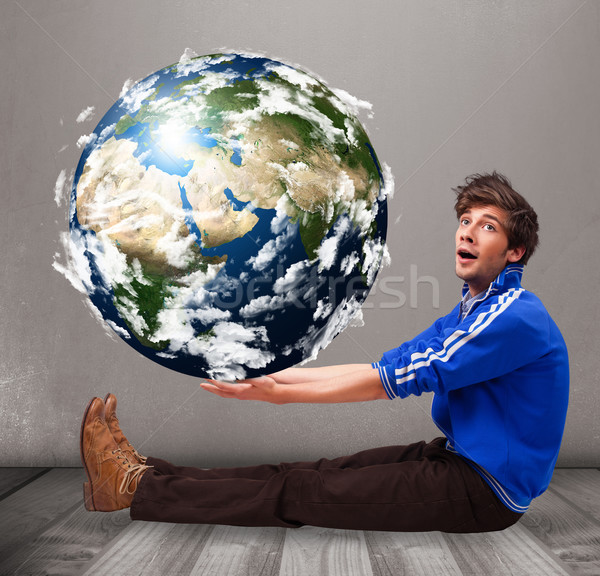 Good-looking man holding 3d planet earth Stock photo © ra2studio