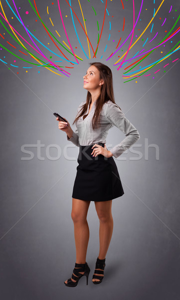 Young girl thinking with colorful abstract lines overhead Stock photo © ra2studio