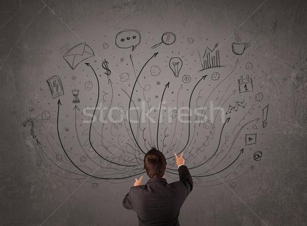 Businessman in front of a chalkboard deciding with arrows and si Stock photo © ra2studio