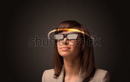 Stock photo: Pretty woman looking with futuristic high tech glasses 