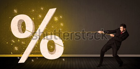 Business man pulling rope with big procent symbol sign  Stock photo © ra2studio