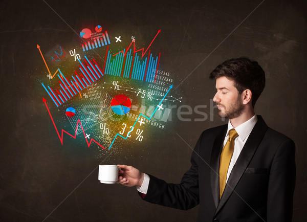 Businessman holding a white cup with diagrams and graphs Stock photo © ra2studio