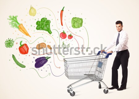 Businessman with shopping cart with vegetables Stock photo © ra2studio