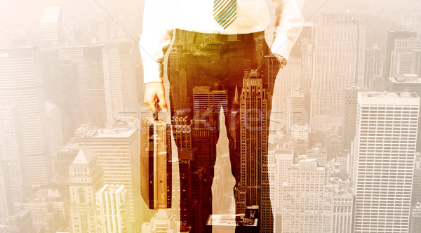 Business man looking at overlay city background Stock photo © ra2studio