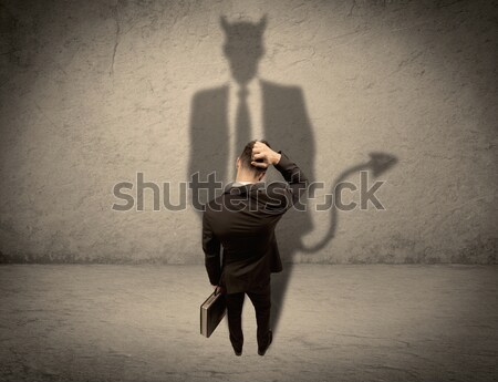 Salesman facing his own devil shadow Stock photo © ra2studio