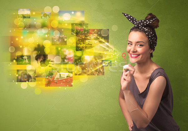 Cute girl blowing colourful glowing memory picture concept Stock photo © ra2studio