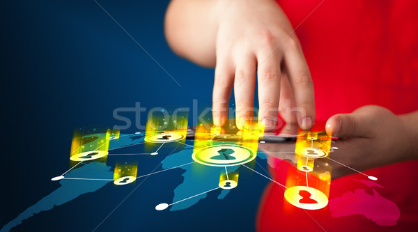 Hand holding tablet device with social network map Stock photo © ra2studio