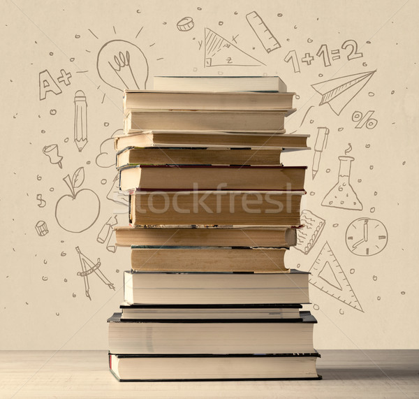 Stock photo: A pile of books on table with school hand drawn doodle sketches