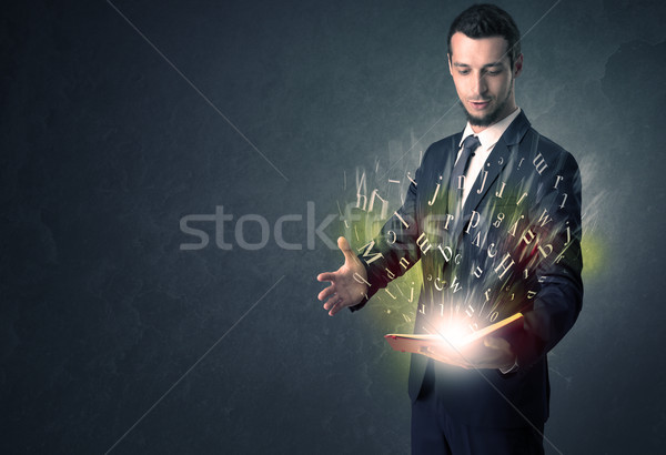 Businessman holding a book. Stock photo © ra2studio