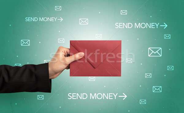 Hand holding envelope with symbols around Stock photo © ra2studio