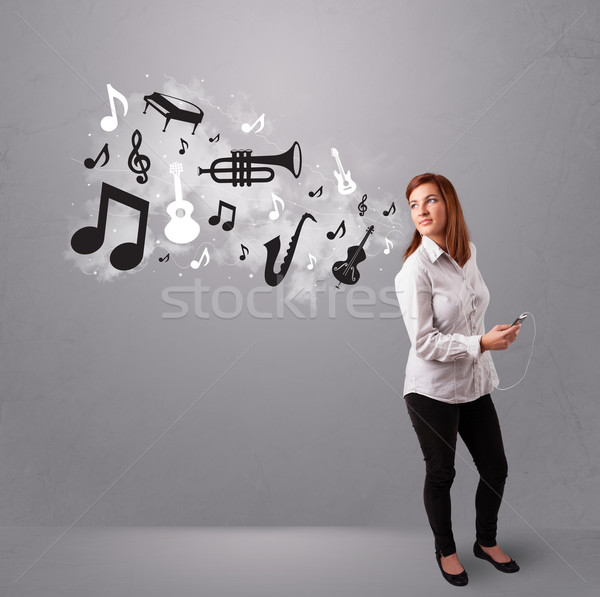 Beautiful young woman singing and listening to music with musical notes and instruments Stock photo © ra2studio