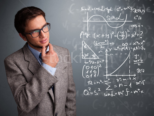 Handsome school boy thinking about complex mathematical signs Stock photo © ra2studio