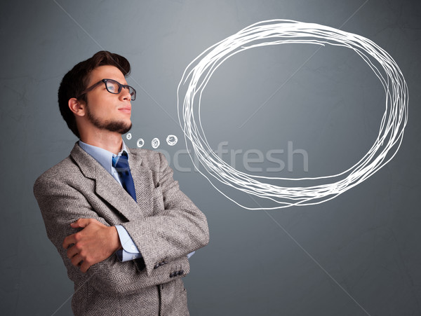 Good-looking young man thinking about speech or thought bubble Stock photo © ra2studio