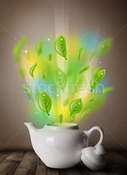 Tea pot with leaves and colorful abstract lights Stock photo © ra2studio