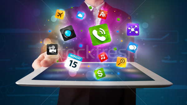Fiatal üzletember tart tabletta modern színes Stock fotó © ra2studio