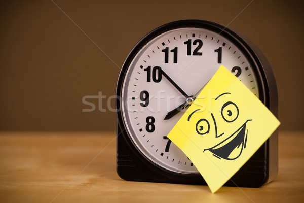 Post-it note with smiley face sticked on clock Stock photo © ra2studio
