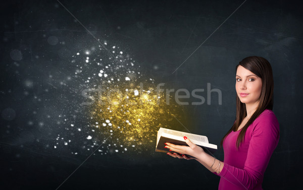 Młodych pani czytania magiczny książki tablicy Zdjęcia stock © ra2studio