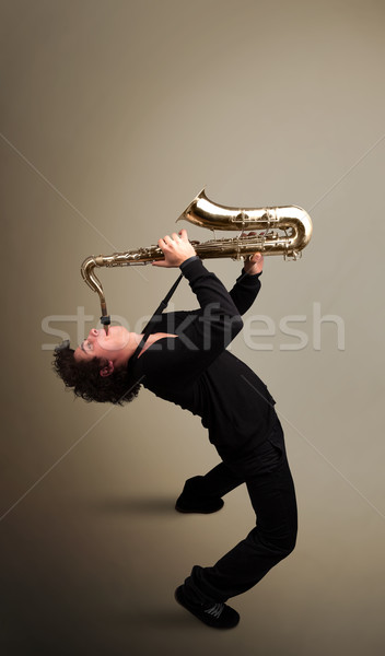 Young musician playing on saxophone Stock photo © ra2studio