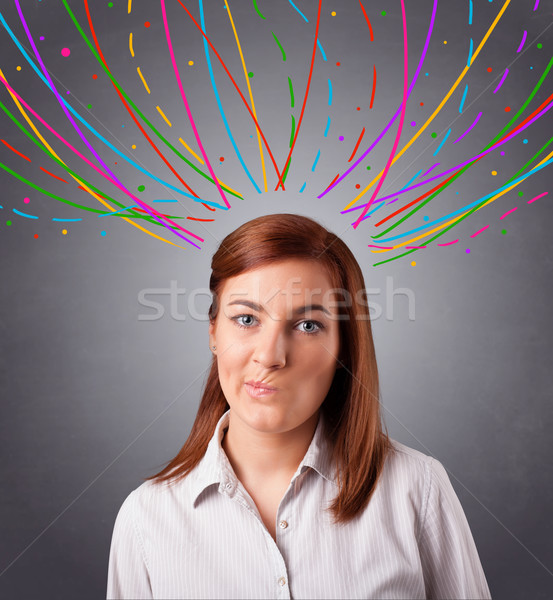 Young girl thinking with colorful abstract lines overhead Stock photo © ra2studio