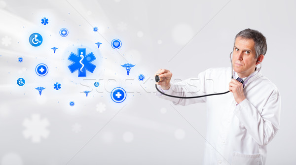 Doctor with blue medical icons Stock photo © ra2studio