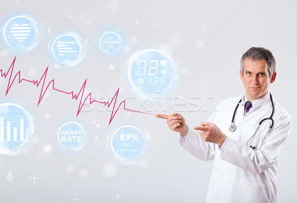 Doctor examinating modern heartbeat graphics Stock photo © ra2studio