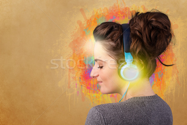 Young woman with headphones listening to music Stock photo © ra2studio