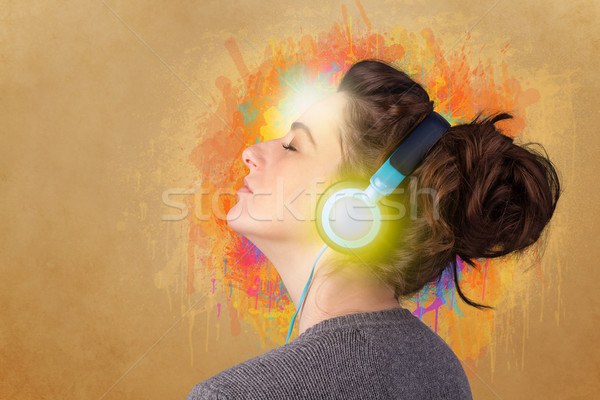 Young woman with headphones listening to music Stock photo © ra2studio