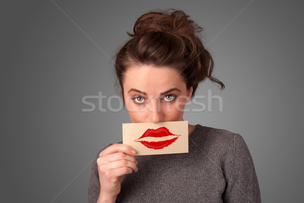 Happy pretty woman holding card with kiss lipstick mark Stock photo © ra2studio