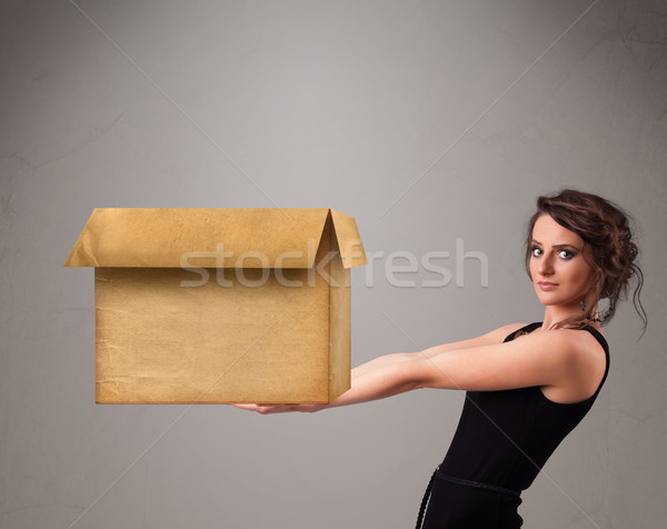 Young woman holding an empty cardboard box Stock photo © ra2studio