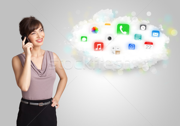 Young woman presenting cloud with colorful app icons and symbols Stock photo © ra2studio